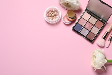 Photo of Flat lay composition with eyeshadow palette and beautiful flowers on pink background, space for text