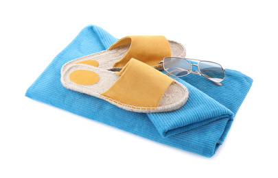 Photo of Blue towel, shoes and sunglasses on white background. Beach objects