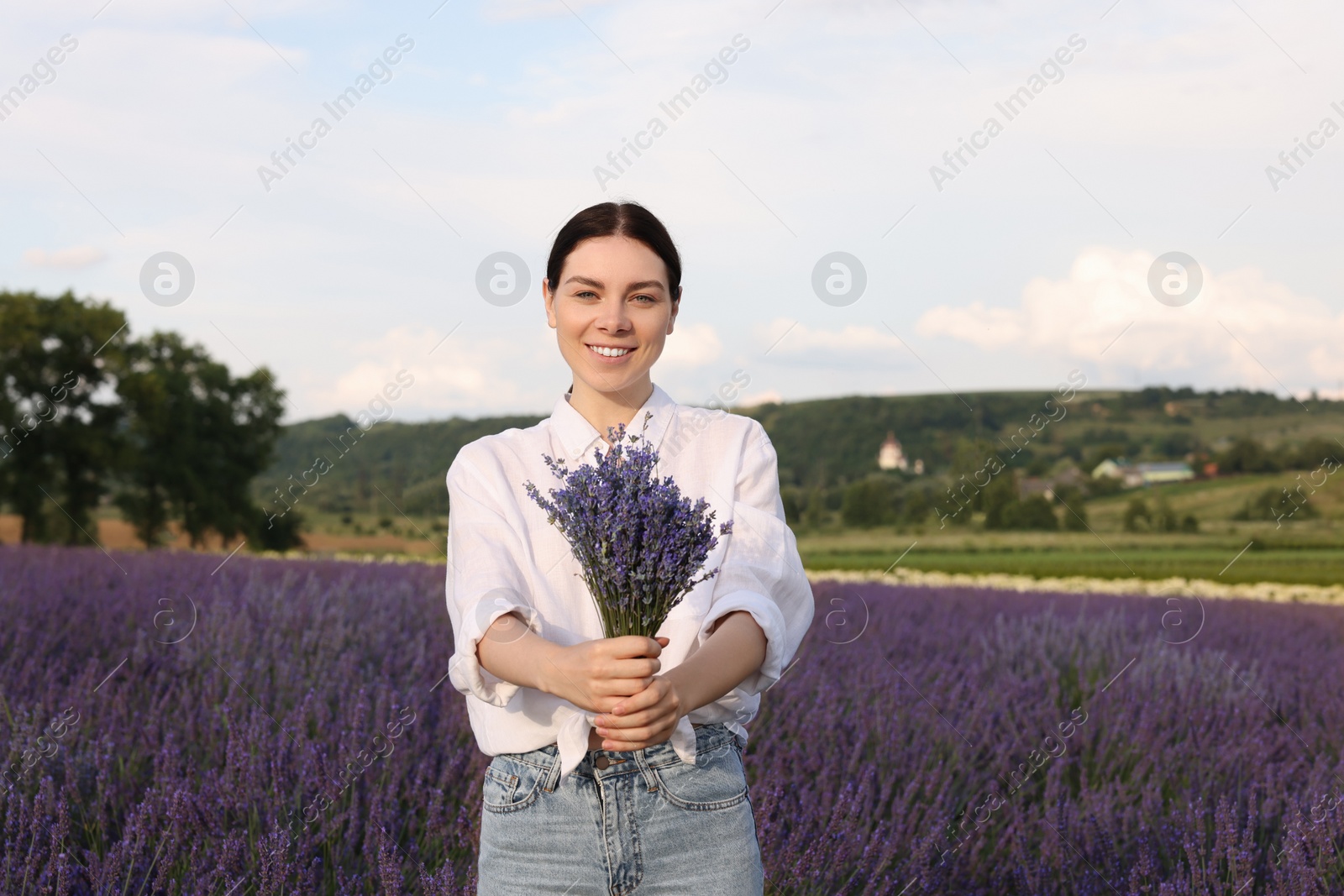 Photo of Portrait of young woman with bouquet in lavender field