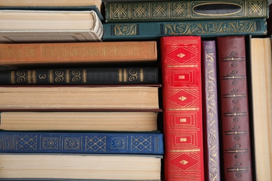 Stack of hardcover books as background, top view