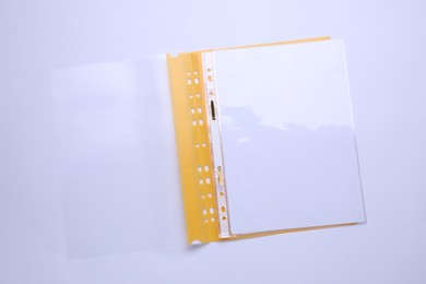 Photo of File folder with punched pockets and paper sheets isolated on white, top view