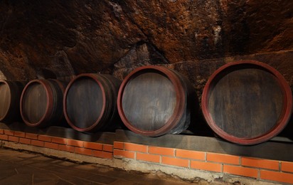 Many barrels of wine stored on shelf in cellar