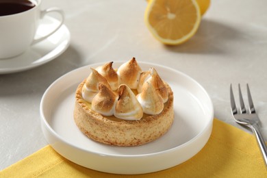 Photo of Delicious lemon meringue pie served on white table