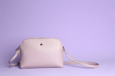 Photo of Stylish elegant woman's bag on lilac background