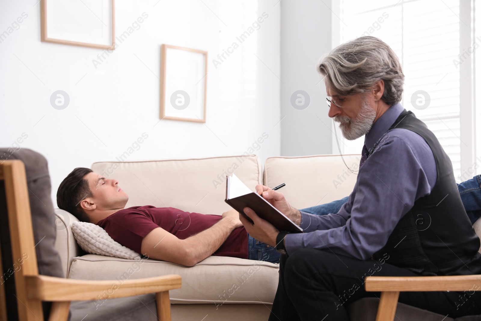 Photo of Psychotherapist and patient in office. Hypnotherapy session