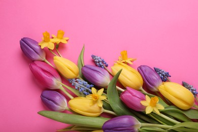 Beautiful different flowers on pink background, flat lay. Space for text