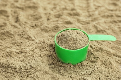 Photo of Measuring spoon and hemp protein powder, closeup. Superfood