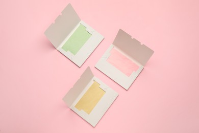 Facial oil blotting tissues on pink background, flat lay. Mattifying wipes