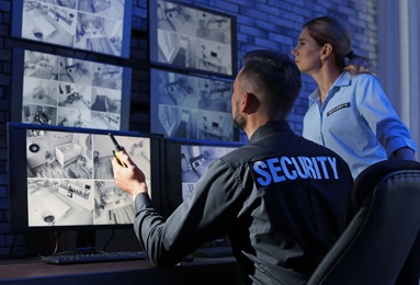 Photo of Security guards monitoring modern CCTV cameras indoors