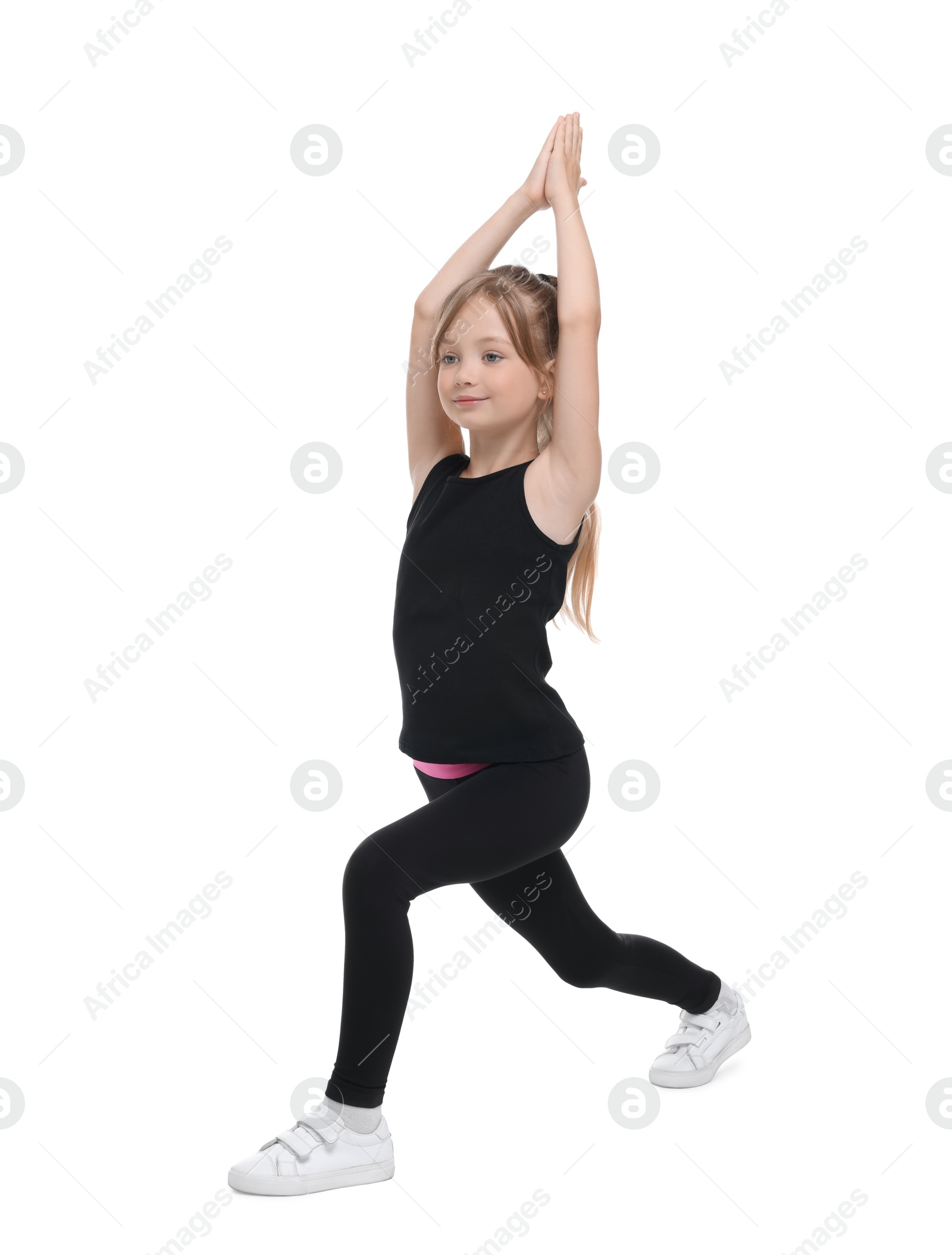 Photo of Little girl doing morning exercise on white background