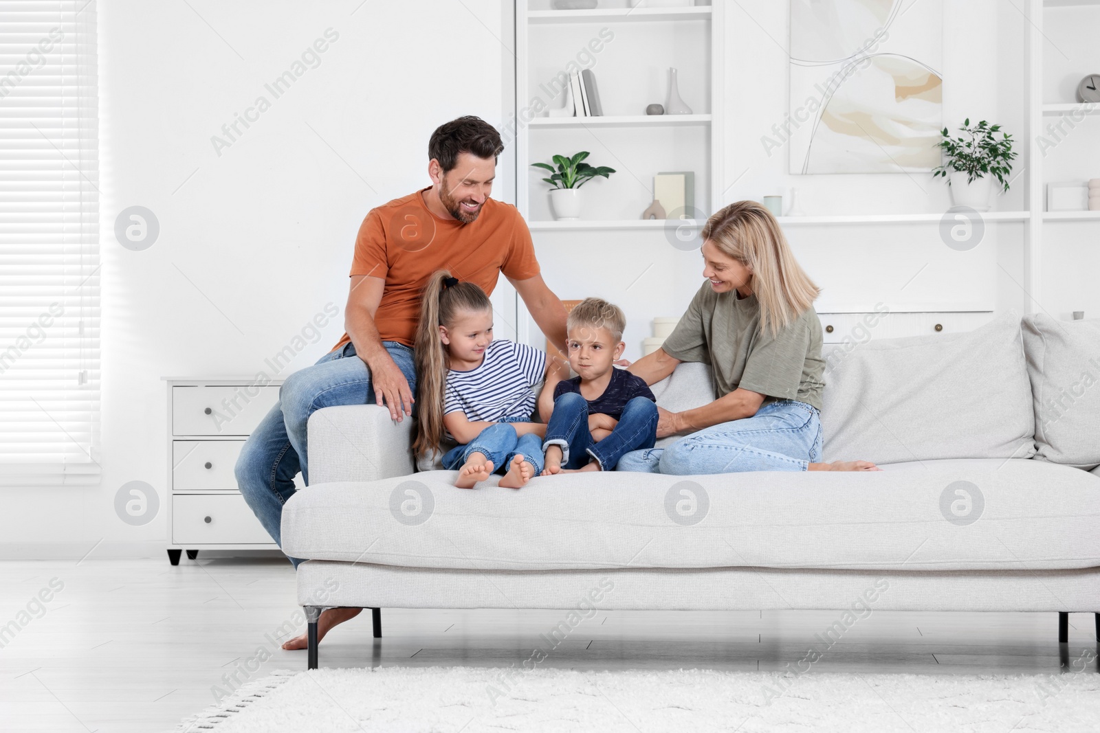 Photo of Happy family spending time together on sofa at home