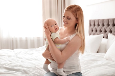 Mother with her little baby in bedroom