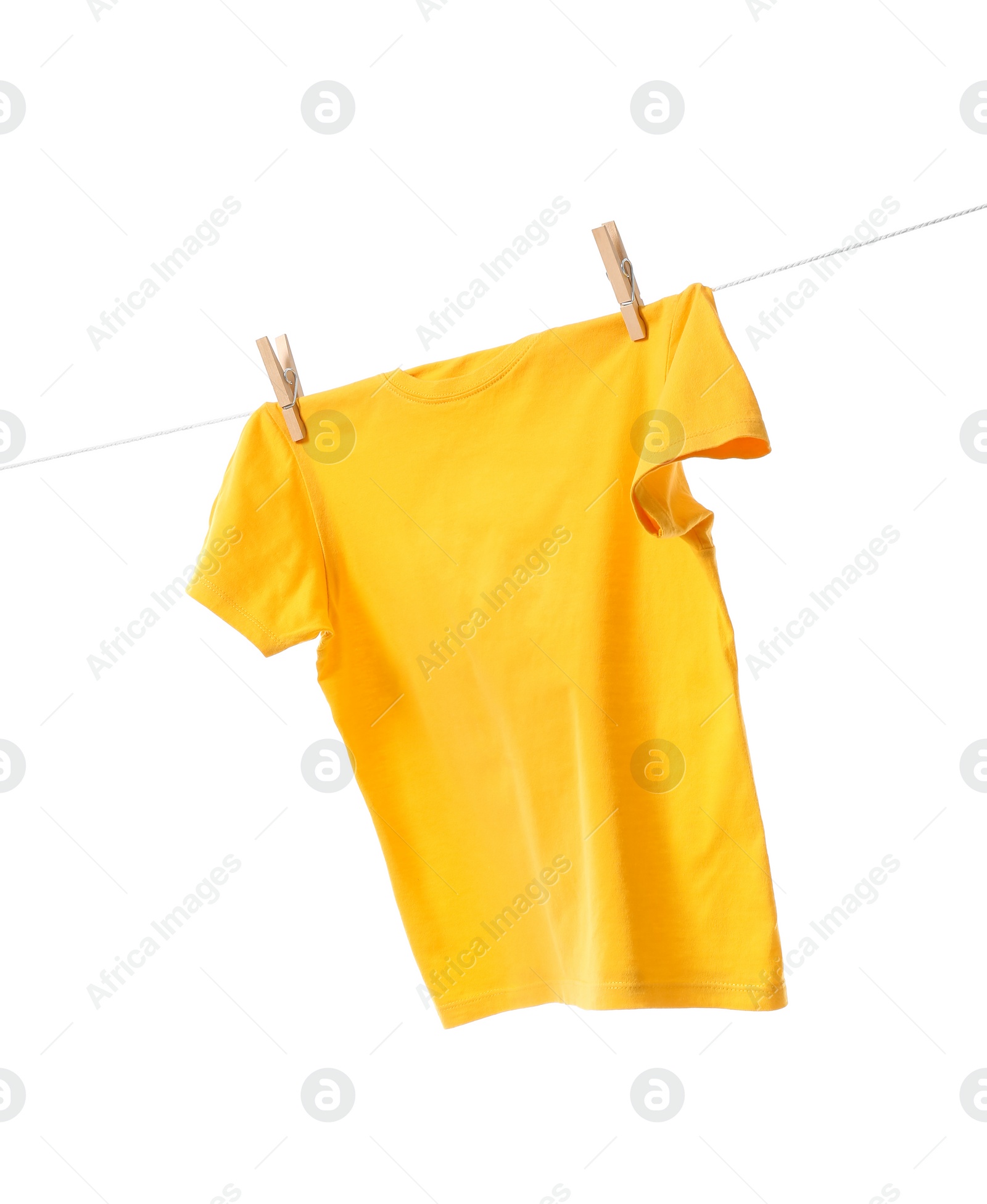 Photo of One yellow t-shirt drying on washing line isolated on white