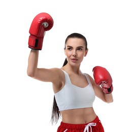 Beautiful woman in boxing gloves training on white background