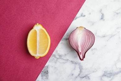 Photo of Beautiful composition with ripe red onion and lemon on color background