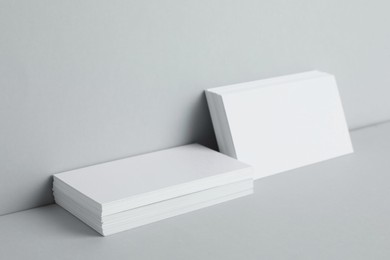 Blank business cards on light gray background. Mockup for design