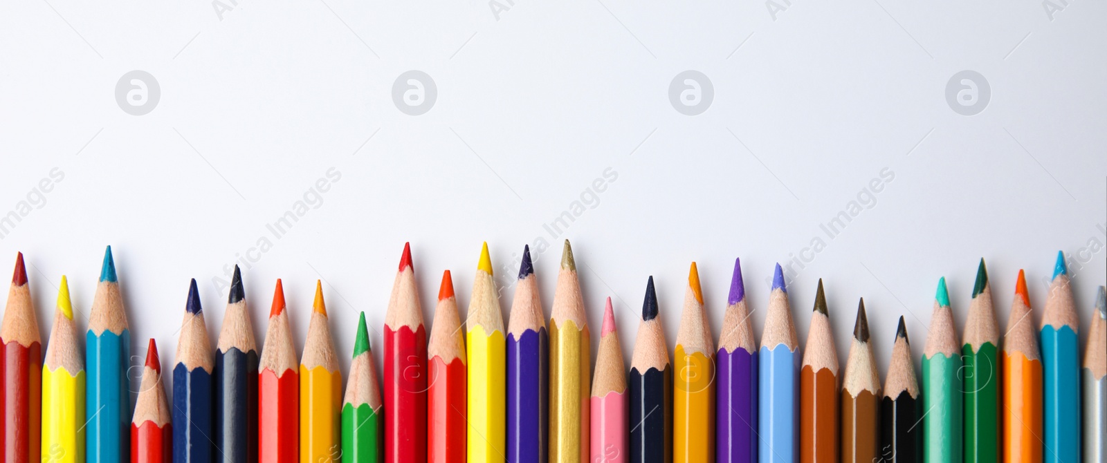 Image of Color pencils on white background, top view with space for text. Banner design