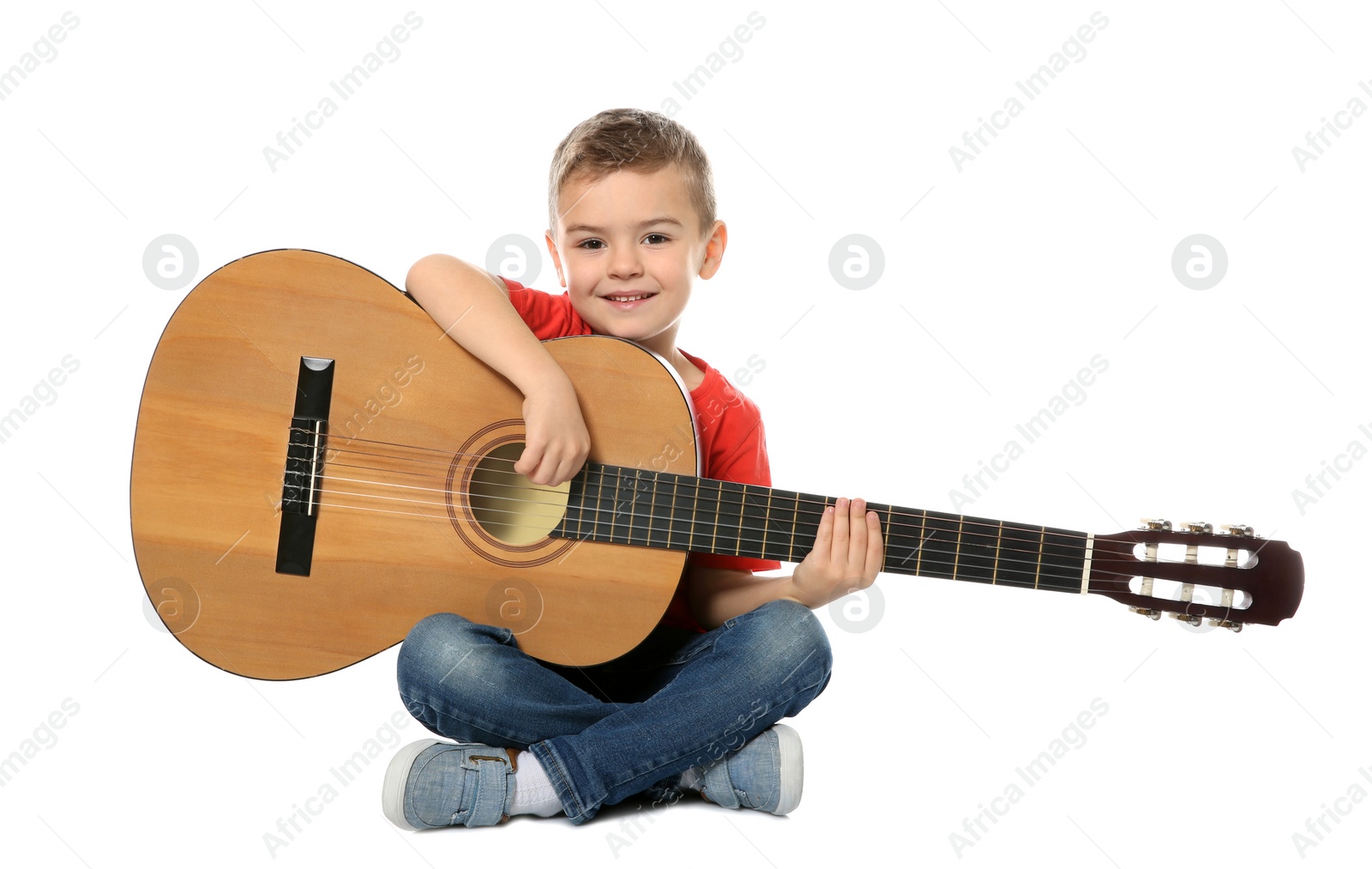 Photo of Little boy with acoustic guitar on white background