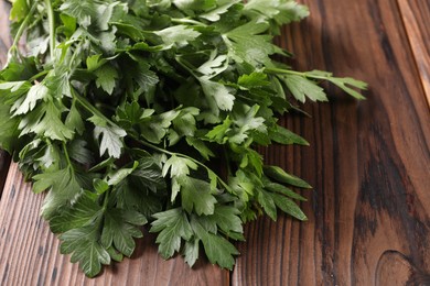 Bunch of fresh green parsley leaves on wooden table, closeup