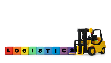 Toy forklift and cubes with word LOGISTICS isolated on white. Wholesale concept