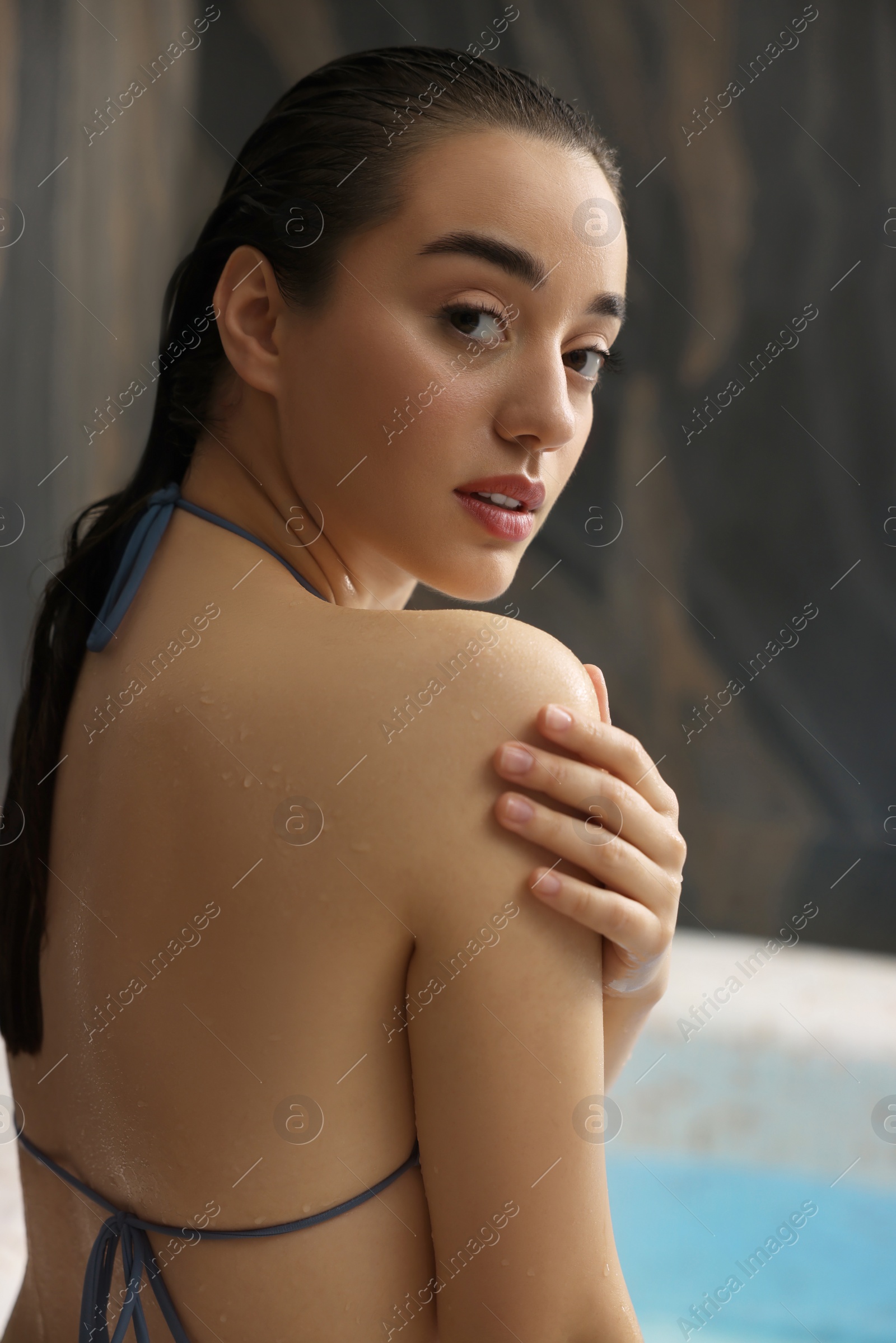 Photo of Beautiful woman near swimming pool in spa center