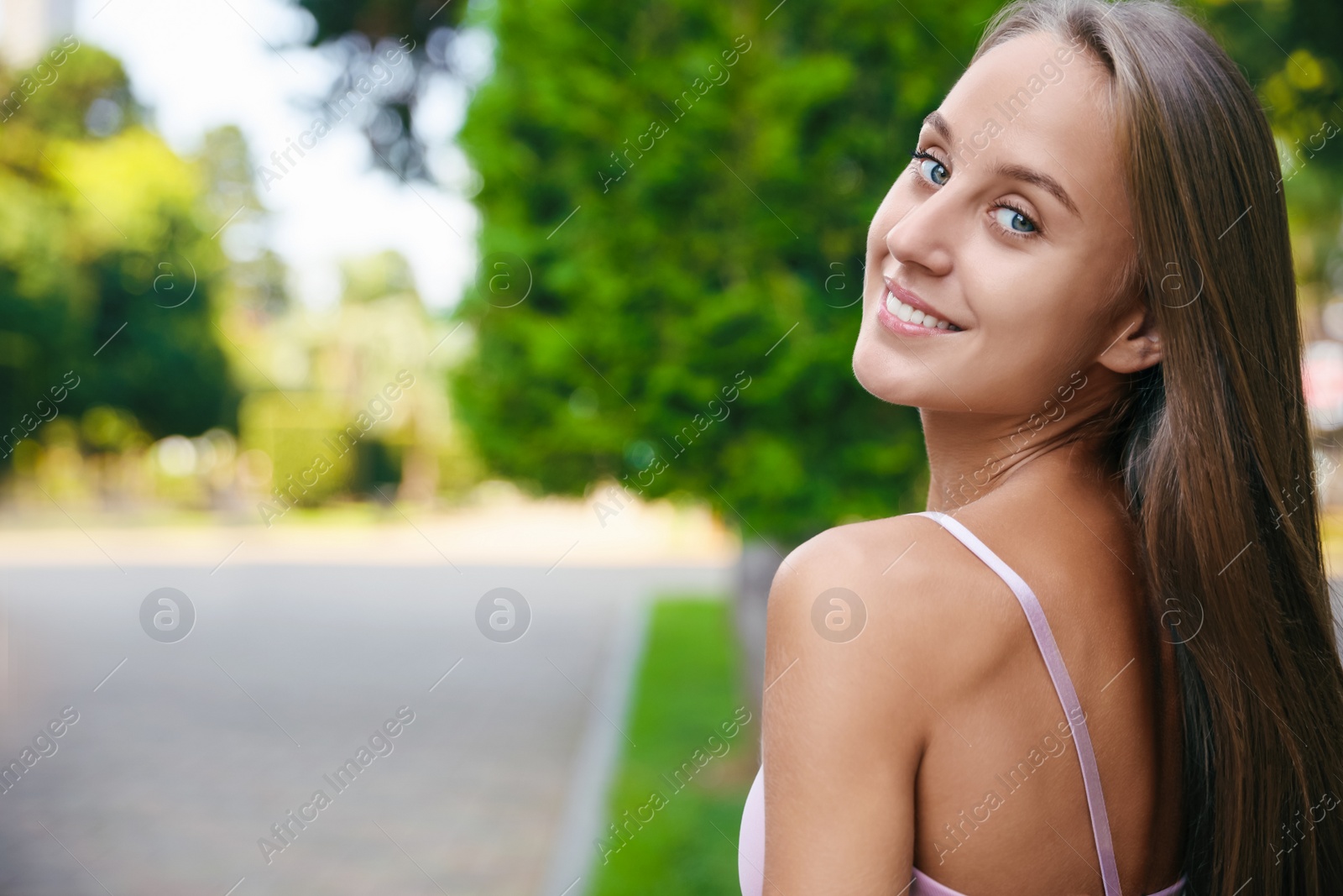 Photo of Portrait of beautiful young woman on city street, space for text