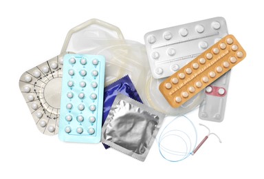 Contraceptive pills, condoms and intrauterine device isolated on white, top view. Different birth control methods