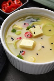 Bowl of delicious miso soup with tofu on table, closeup