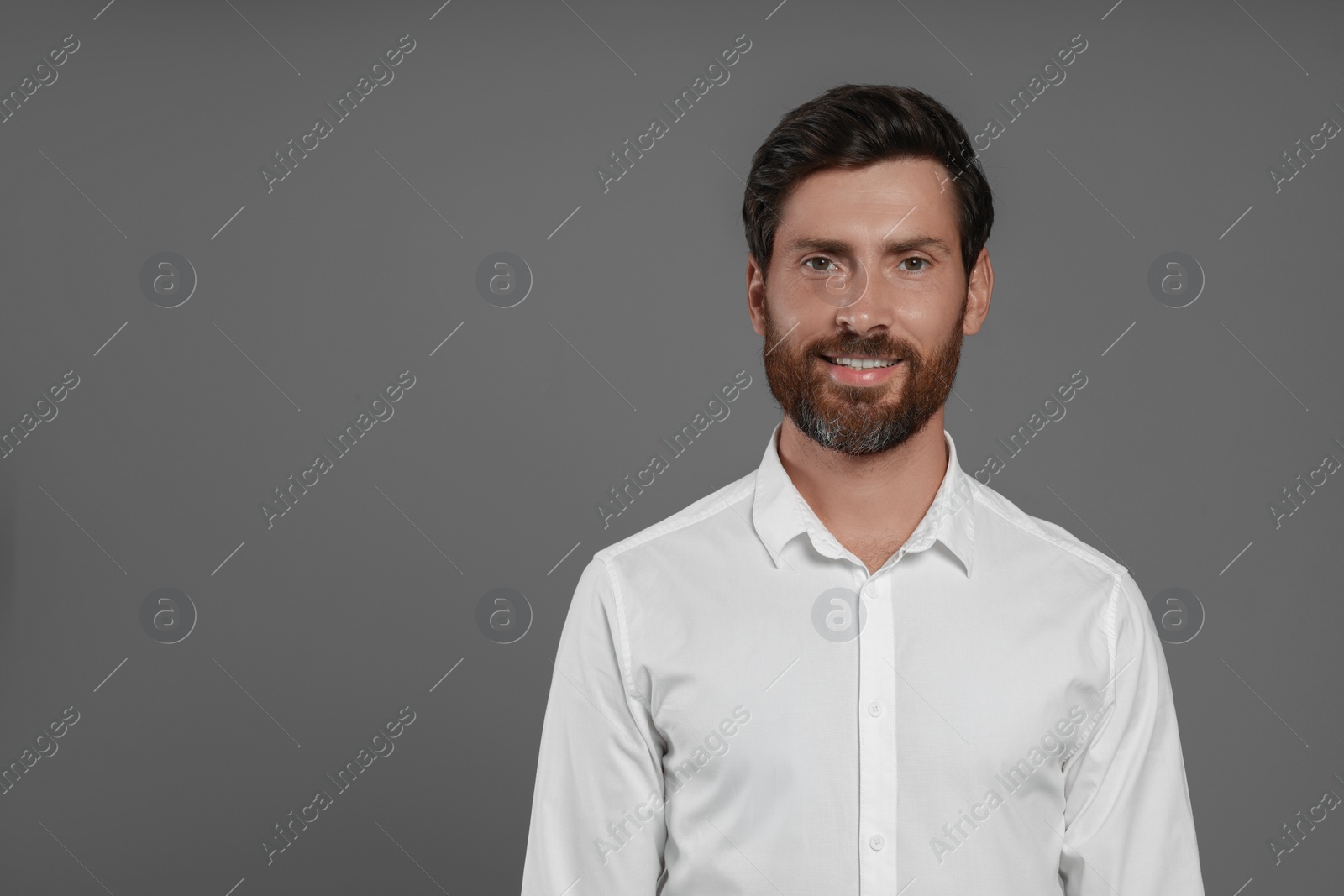 Photo of Portrait of handsome bearded man on grey background, space for text