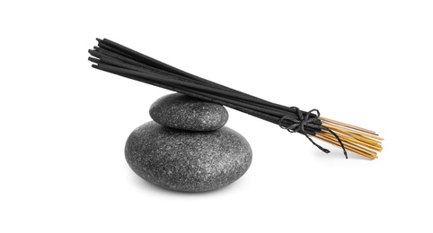 Aromatic incense sticks and spa stones on white background