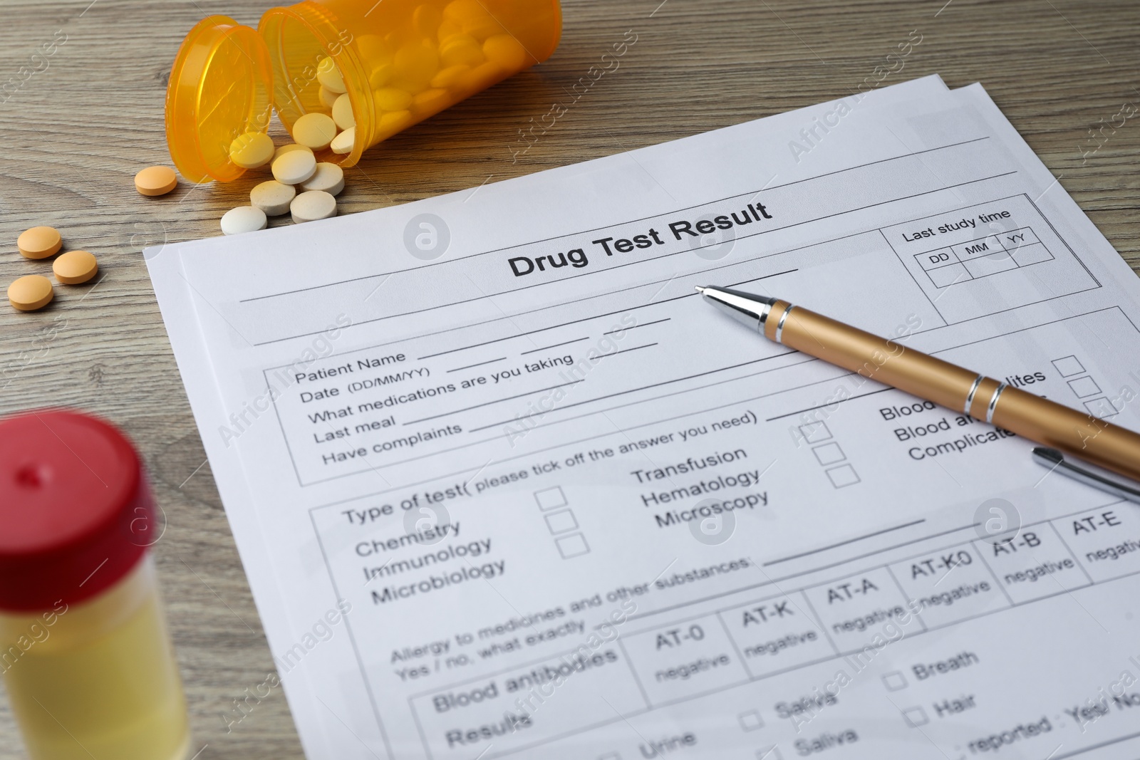 Photo of Drug test result form, pills and pen on wooden table, closeup