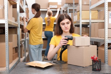 Young post office employees working in warehouse