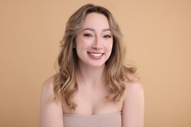 Photo of Portrait of smiling woman on beige background