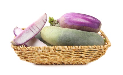 Photo of Purple and green daikon radishes in wicker basket isolated on white