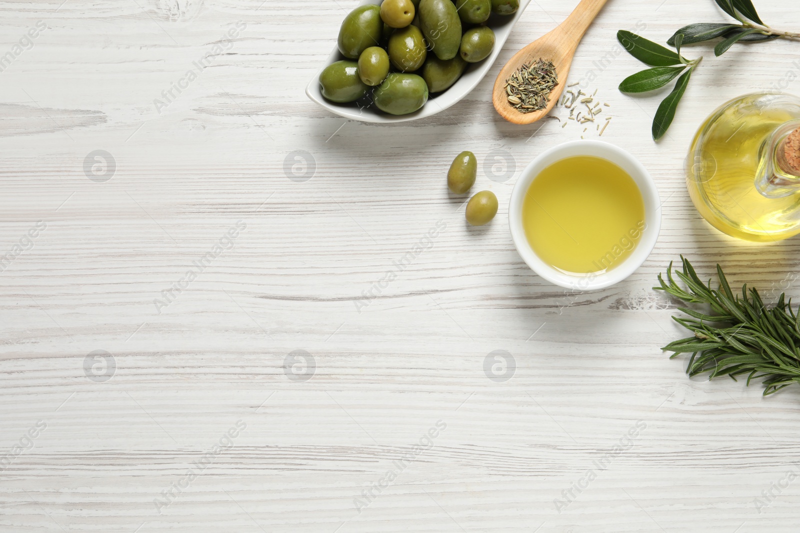 Photo of Flat lay composition with olive oil on white wooden table, flat lay. Space for text