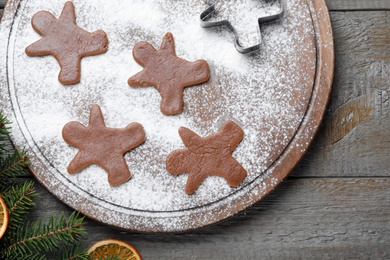 Flat lay composition with homemade gingerbread man cookies on wooden table