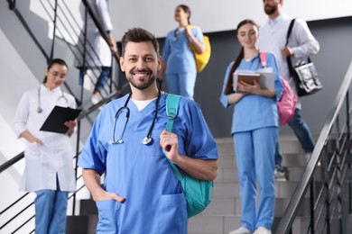 Photo of Portrait of medical student with stethoscope on staircase in college, space for text