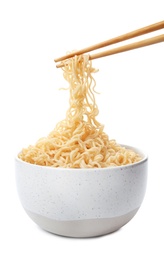 Photo of Chopsticks with tasty instant noodles over bowl isolated on white