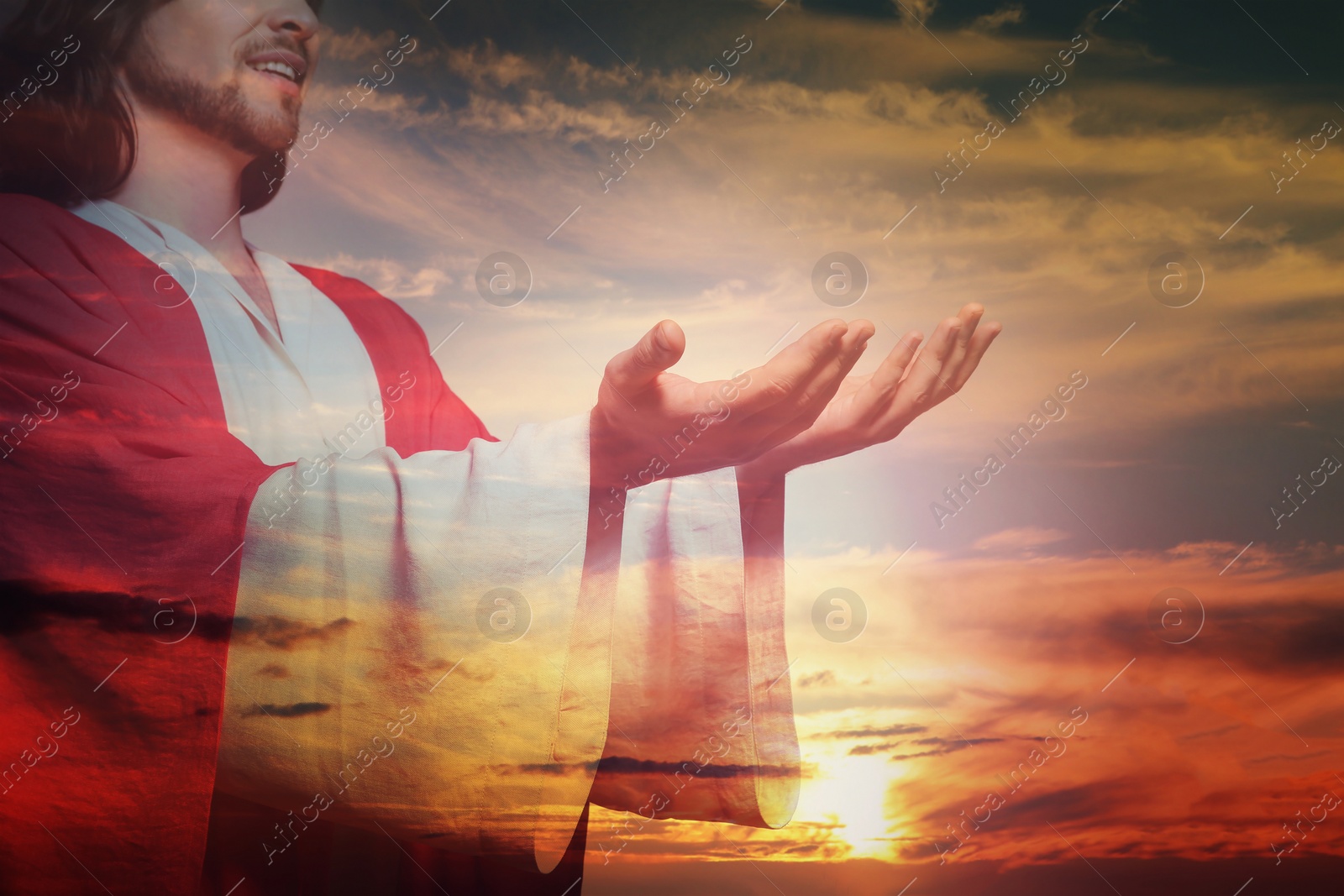 Image of Jesus Christ reaching out his hands and praying at sunset, double exposure