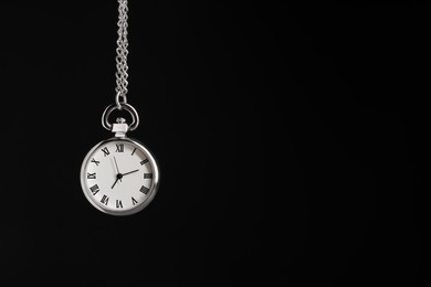 Photo of Beautiful vintage pocket watch with silver chain on black background, space for text. Hypnosis session
