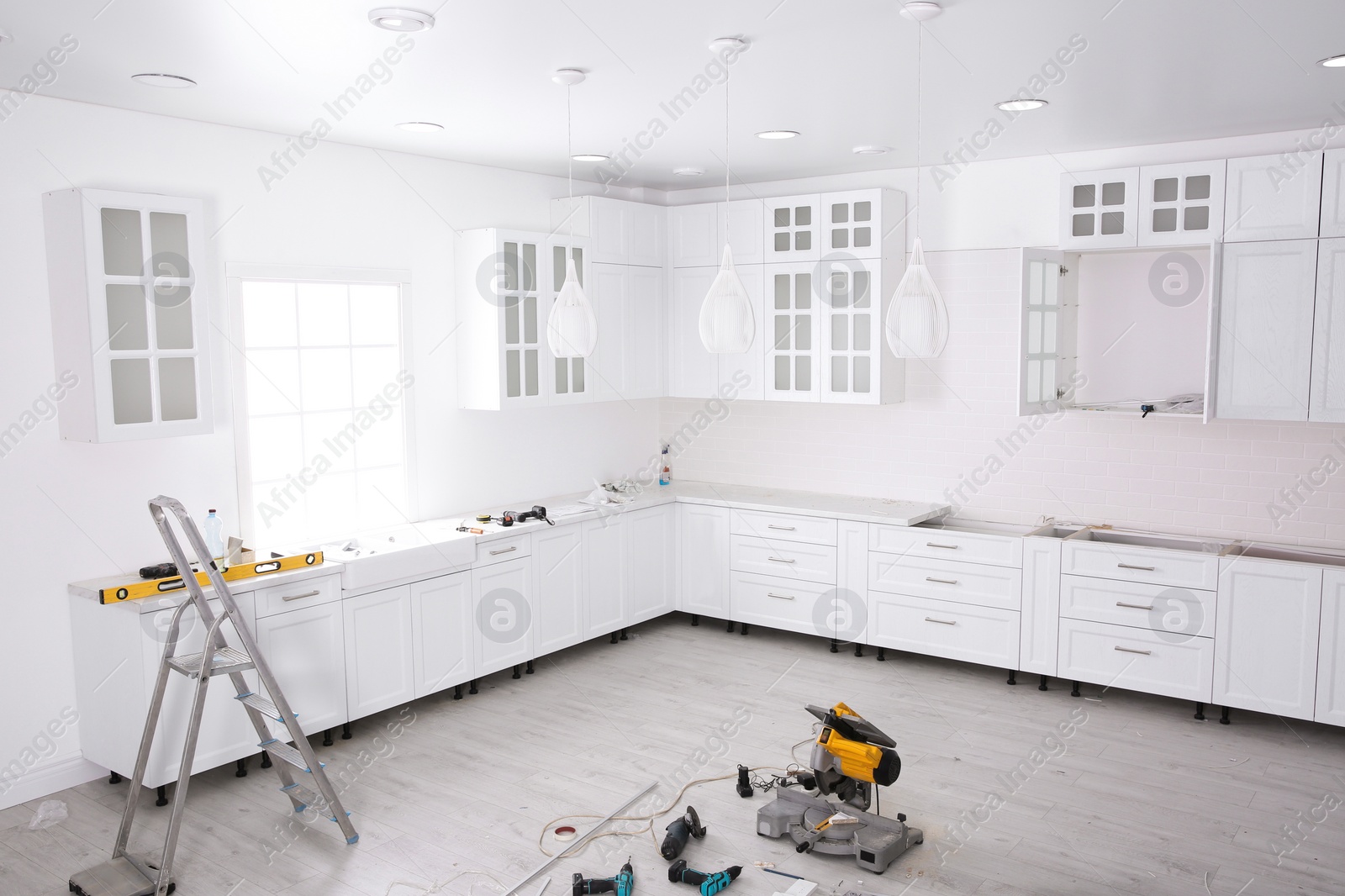 Photo of Renovated kitchen interior with stylish furniture and maintenance equipment