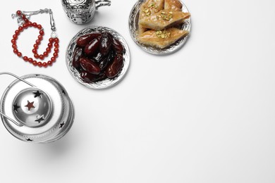 Photo of Composition with Arabic lantern and snacks on white background, top view
