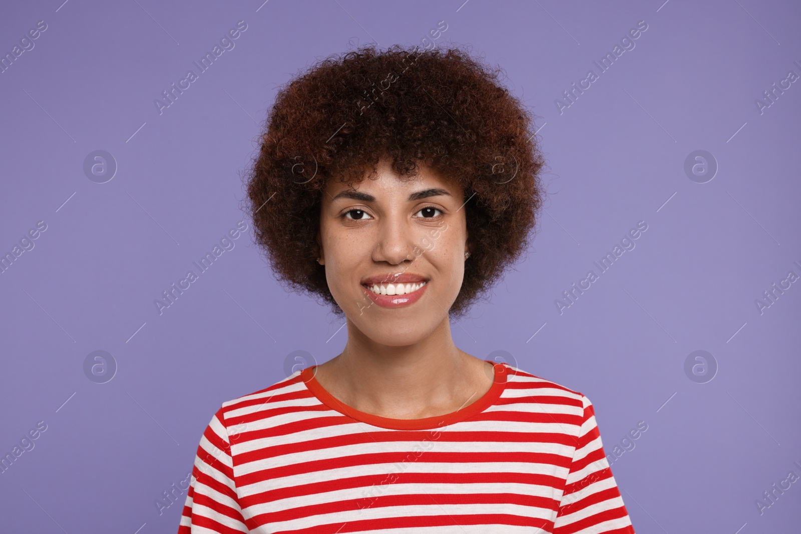 Photo of Portrait of happy young woman on purple background