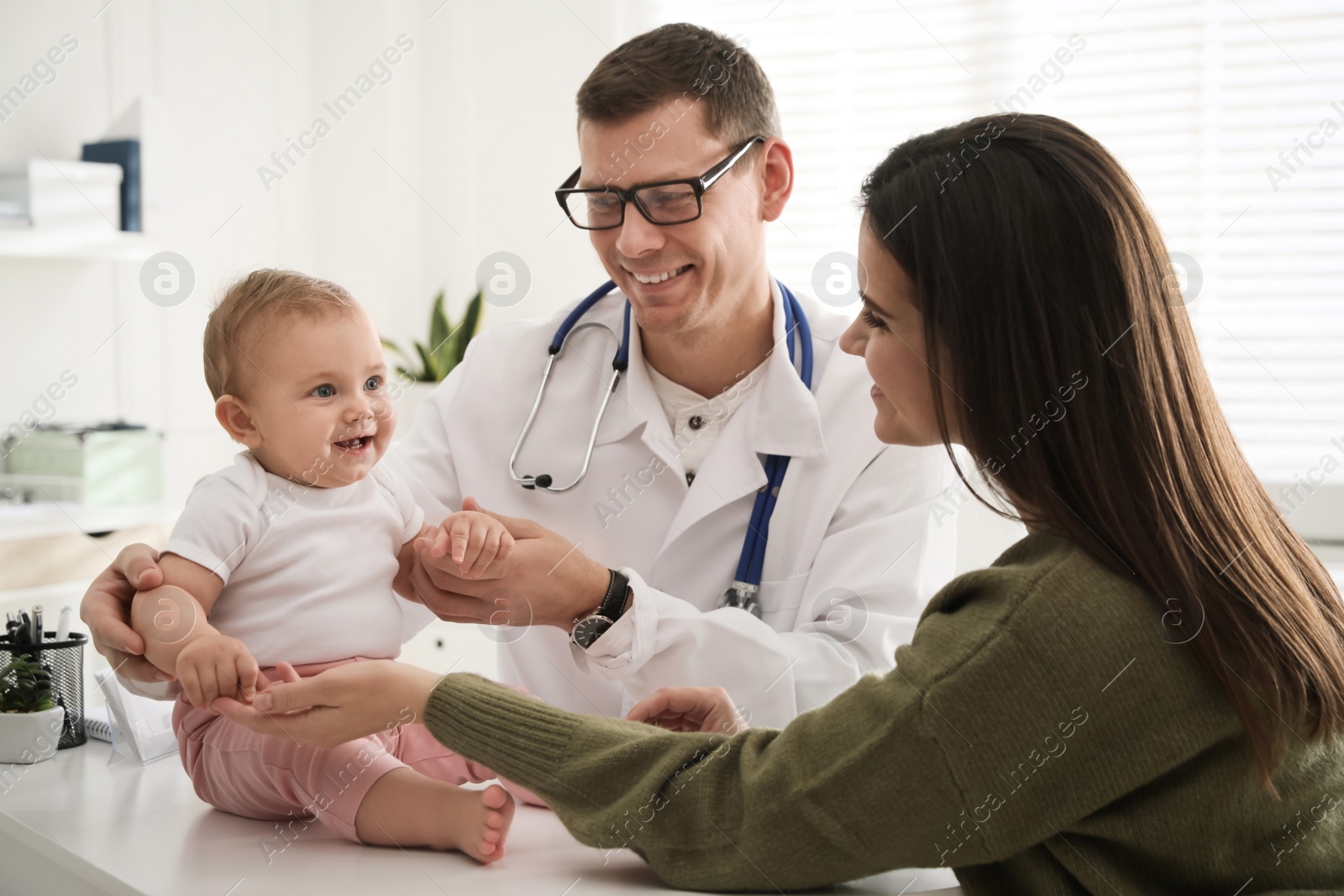 Photo of Mother with her cute baby visiting pediatrician in clinic