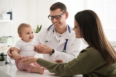 Photo of Mother with her cute baby visiting pediatrician in clinic