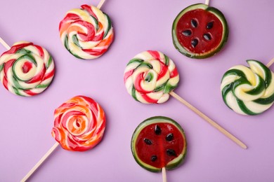 Photo of Many different lollipops on violet background, flat lay