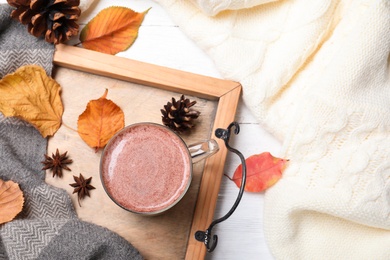 Photo of Flat lay composition with cup of hot drink on white wooden table. Cozy autumn atmosphere