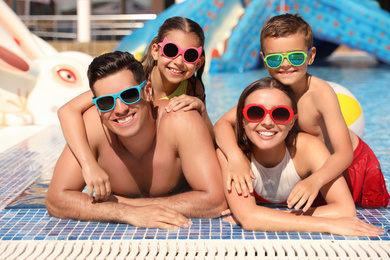 Happy family in swimming pool. Summer vacation