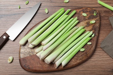 Photo of Flat lay composition with fresh lemongrass stalks on wooden table