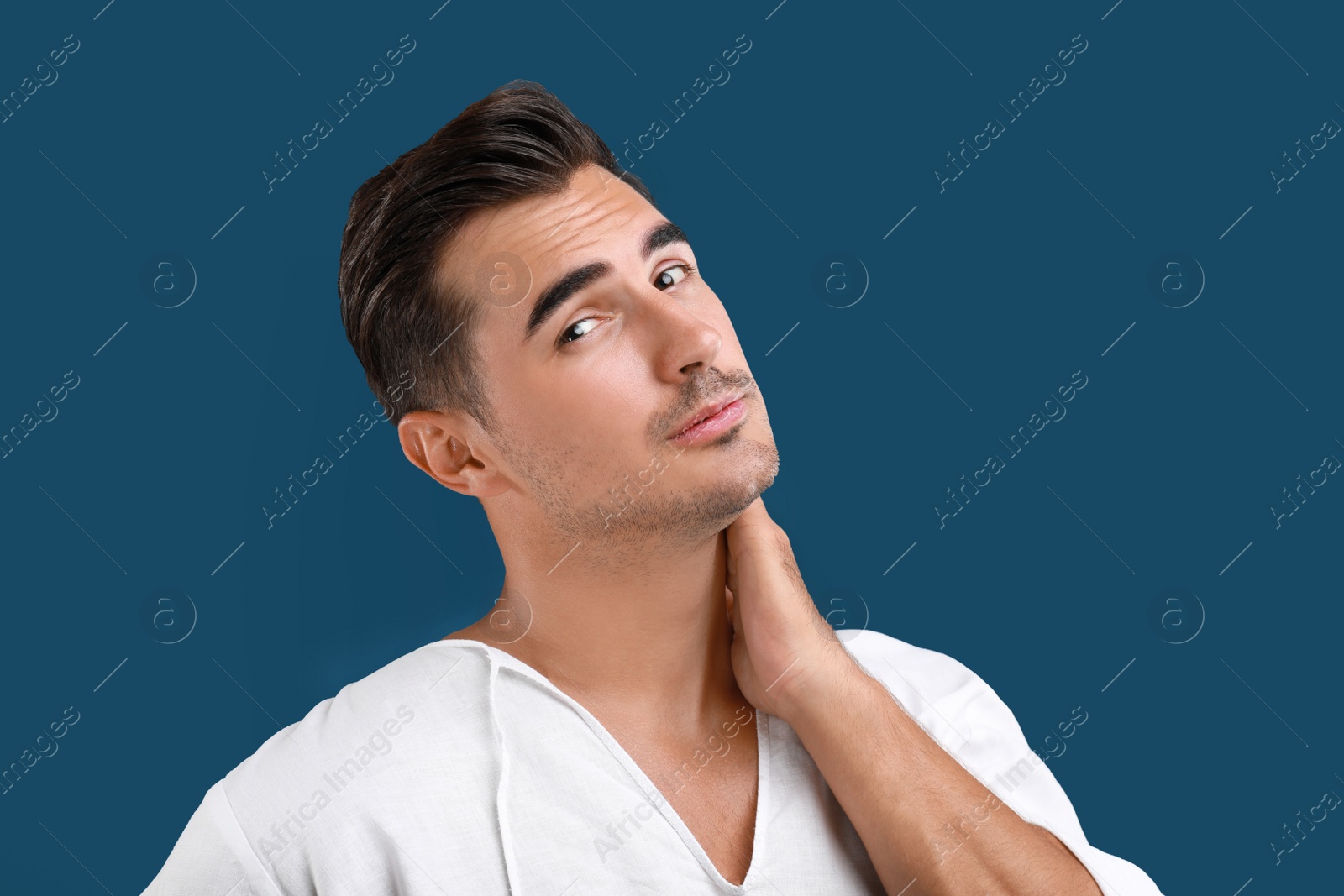 Photo of Portrait of handsome young man on blue background